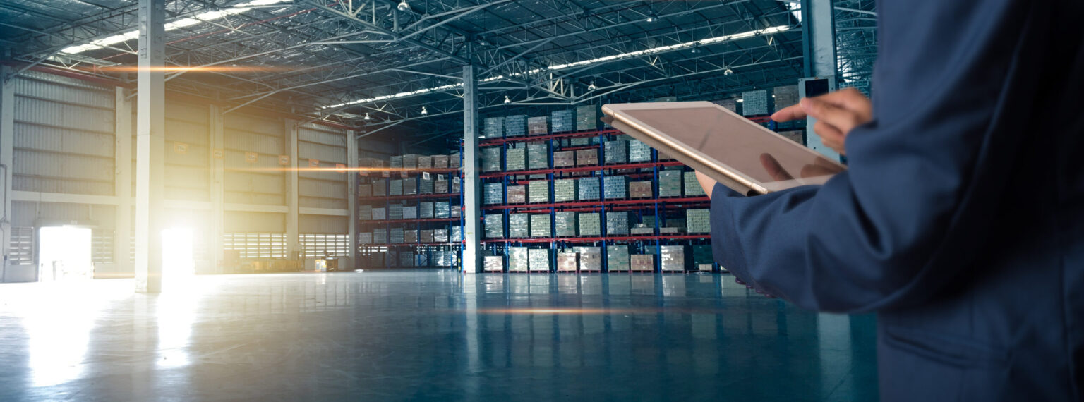 Businessman manager using tablet check and control for workers with Modern Trade warehouse logistics. Industry 5.0 concept